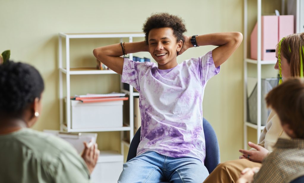 Difficult teenager attending psychotherapy class